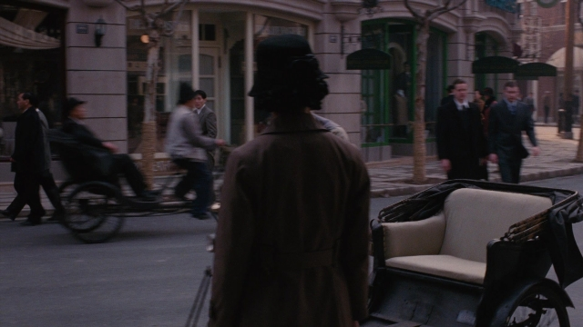 Wide shot frame from Se, jie — standing, walking, street