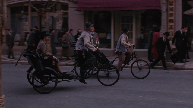 Wide shot frame from Se, jie — walking, street, wheel
