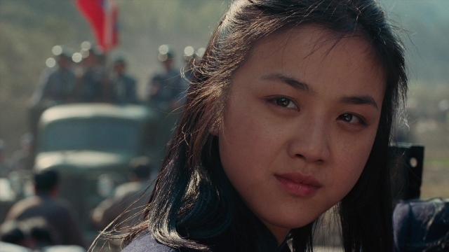 Close-up frame from Se, jie — street, face, hair
