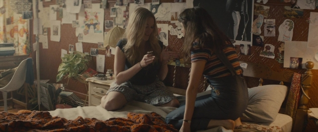 Wide shot frame from The Diary of a Teenage Girl — sitting, dialogue, bed