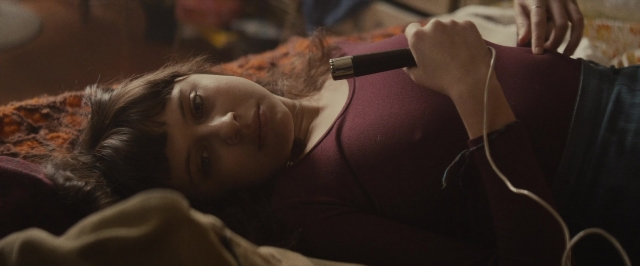 Frame from The Diary of a Teenage Girl — room, bed, hand