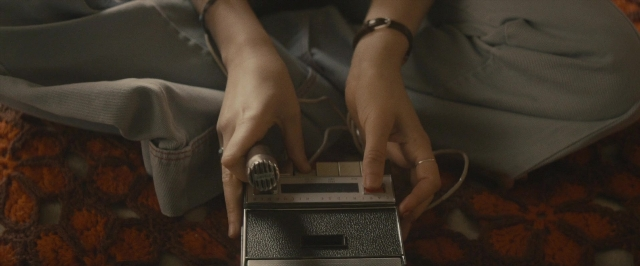 Medium shot frame from The Diary of a Teenage Girl — sitting, room, bed