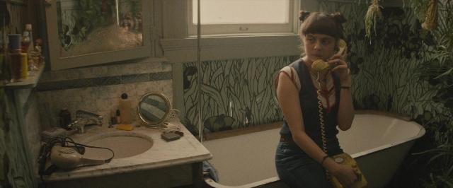 Wide shot frame from The Diary of a Teenage Girl — sitting, dialogue, phone
