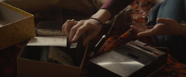 Frame from The Diary of a Teenage Girl — sitting, bed, shirt