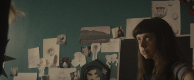 Wide shot frame from The Diary of a Teenage Girl — standing, dog, face