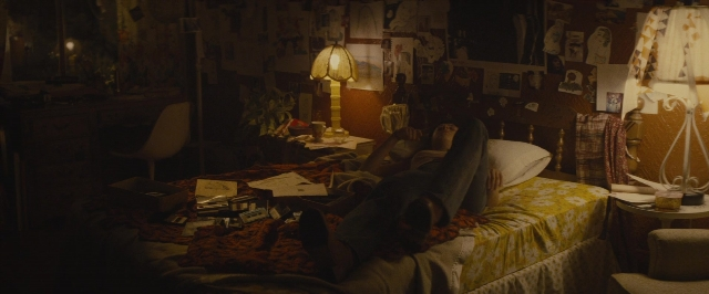 Wide shot frame from The Diary of a Teenage Girl — book, room, bed