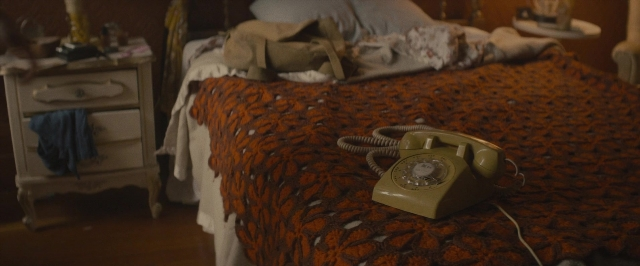 Wide shot frame from The Diary of a Teenage Girl — room, table, bed