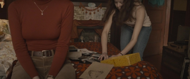 Wide shot frame from The Diary of a Teenage Girl — sitting, standing, room