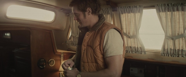 Wide shot frame from The Diary of a Teenage Girl — standing, phone, car