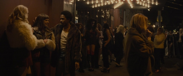Wide shot frame from The Diary of a Teenage Girl — standing, dialogue, street