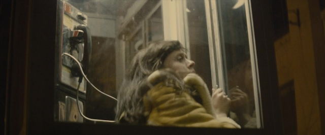 Wide shot frame from The Diary of a Teenage Girl — sitting, phone, glass