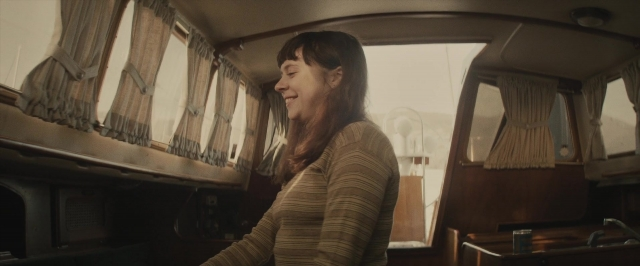 Wide shot frame from The Diary of a Teenage Girl — standing, car, face