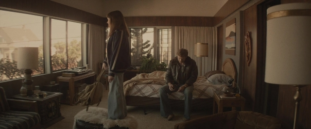 Wide shot frame from The Diary of a Teenage Girl — sitting, standing, room