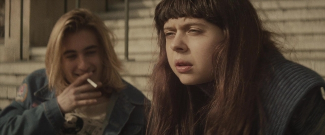 Medium shot frame from The Diary of a Teenage Girl — sitting, hand, face