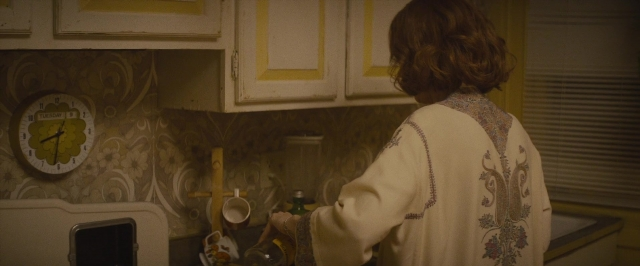Frame from The Diary of a Teenage Girl — standing, kitchen, clock