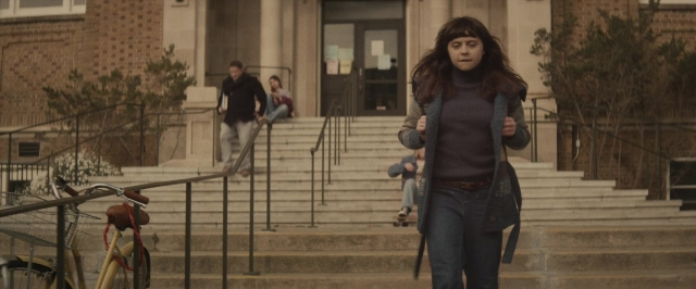 Wide shot frame from The Diary of a Teenage Girl — walking, door, bicycle
