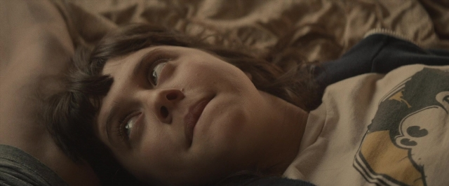 Frame from The Diary of a Teenage Girl — bed, shirt, face