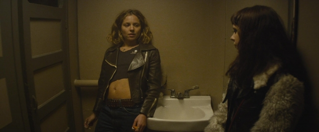 Wide shot frame from The Diary of a Teenage Girl — standing, mirror, coat