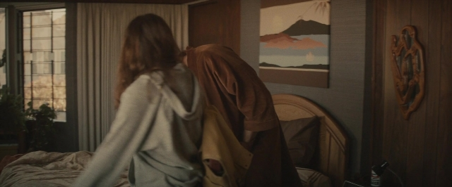 Wide shot frame from The Diary of a Teenage Girl — standing, bed, house