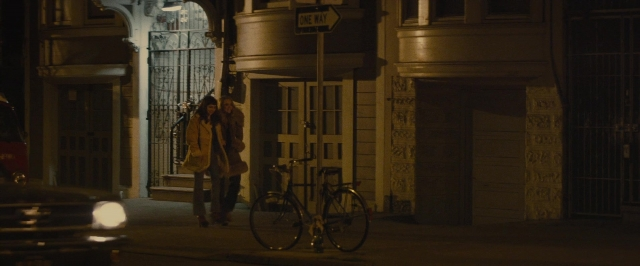 Wide shot frame from The Diary of a Teenage Girl — door, street, car