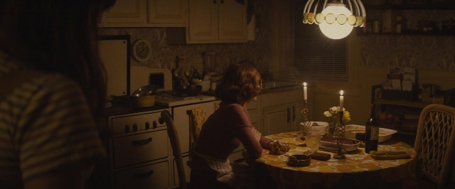 Wide shot frame from The Diary of a Teenage Girl — sitting, standing, plate
