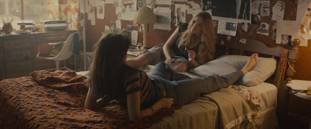 Wide shot frame from The Diary of a Teenage Girl — bed, phone, hand