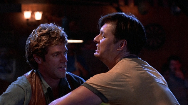 Wide shot frame from The Accused — room, dialogue, shirt