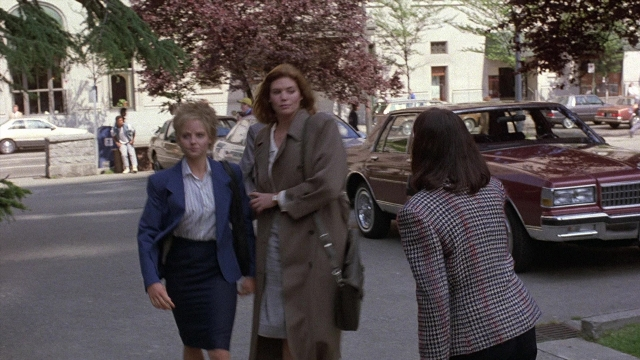 Wide shot frame from The Accused — walking, street, car