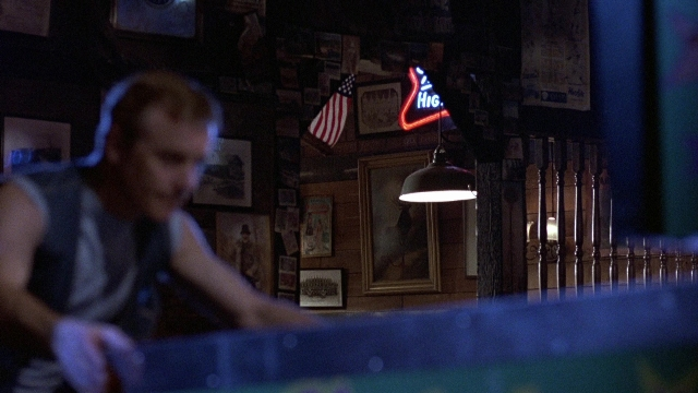 Frame from The Accused — room, table, shirt