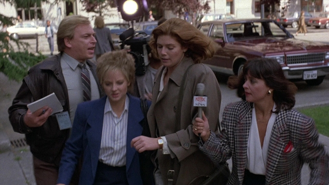 Wide shot frame from The Accused — walking, dialogue, street