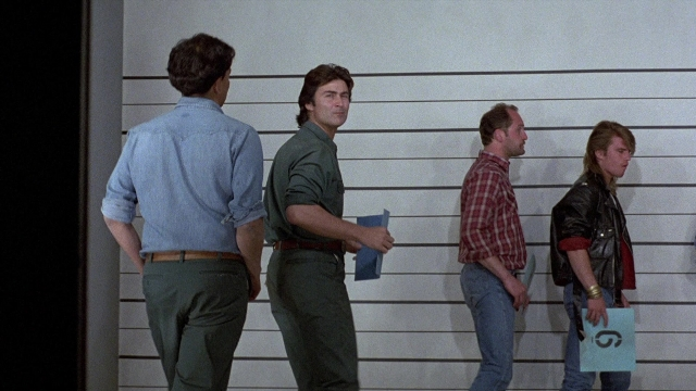 Wide shot frame from The Accused — standing, dialogue, shirt