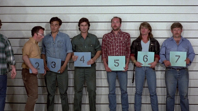 Wide shot frame from The Accused — standing, shirt, person