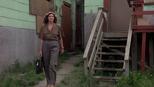Wide shot frame from The Accused — walking, door, hand