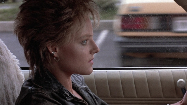 Wide shot frame from The Accused — sitting, street, car