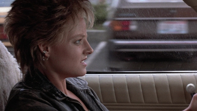 Medium shot frame from The Accused — sitting, car, face