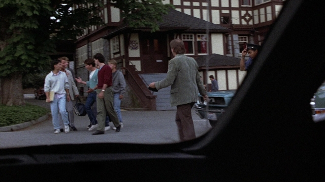 Wide shot frame from The Accused — walking, street, car