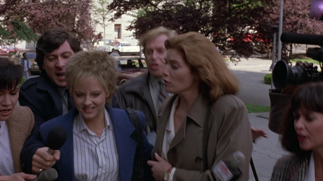 Wide shot frame from The Accused — dialogue, street, hair