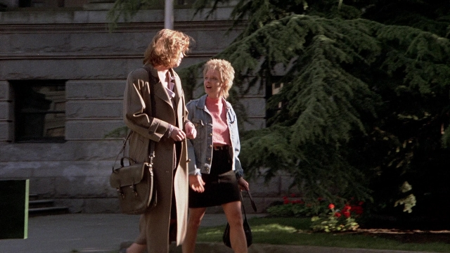 Frame from The Accused — walking, street, coat