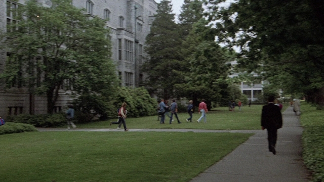 Wide shot frame from The Accused — walking, person, building