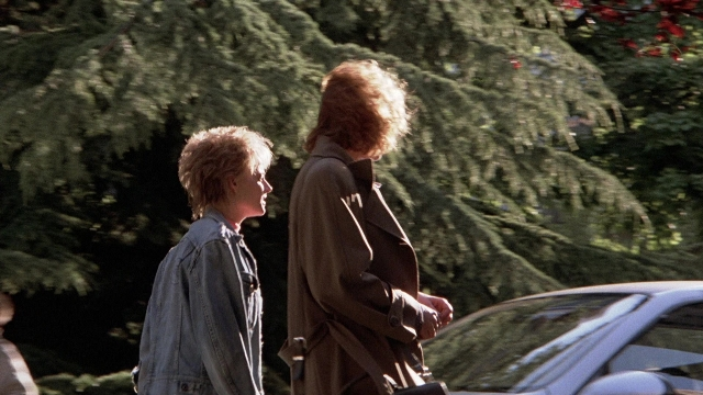Wide shot frame from The Accused — walking, dialogue, street