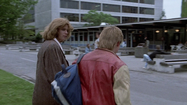 Frame from The Accused — sitting, walking, dialogue