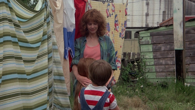 Wide shot frame from The Accused — standing, shirt, hair