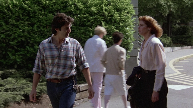 Wide shot frame from The Accused — walking, street, shirt