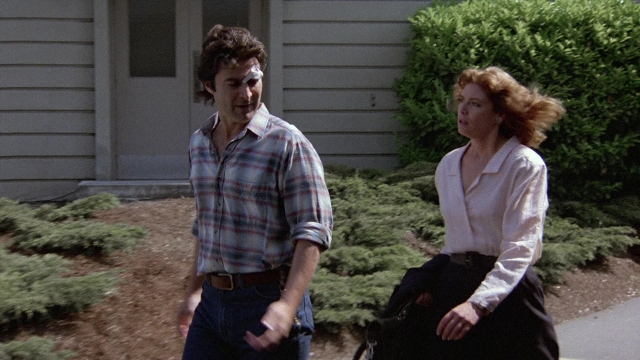 Wide shot frame from The Accused — walking, street, hand