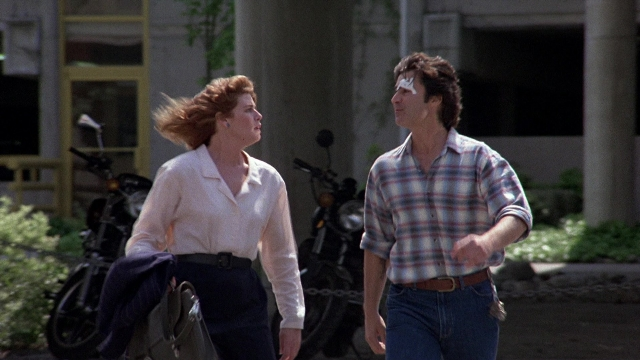 Wide shot frame from The Accused — walking, street, shirt
