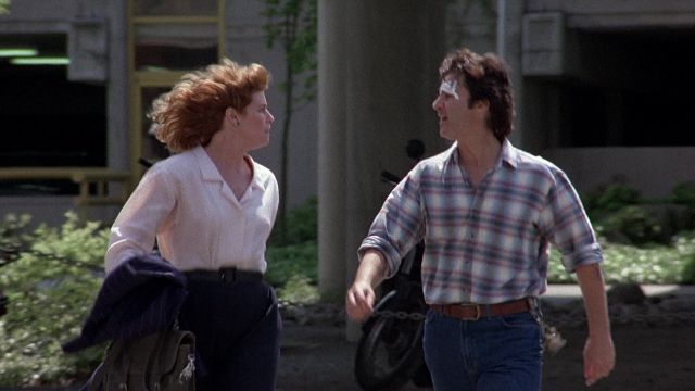 Wide shot frame from The Accused — walking, door, street