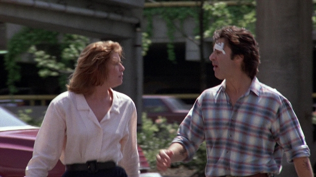 Wide shot frame from The Accused — walking, street, shirt