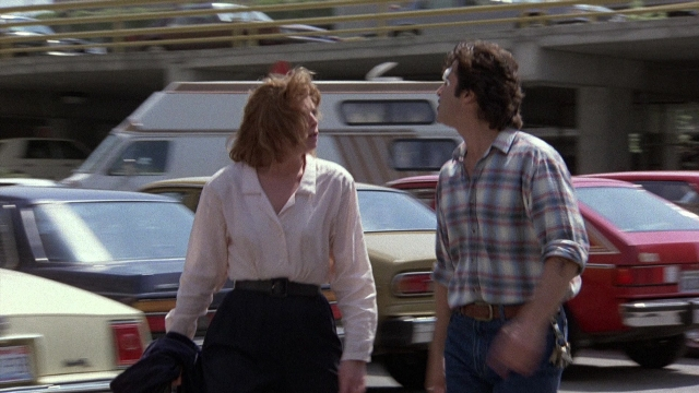 Frame from The Accused — walking, car, hand