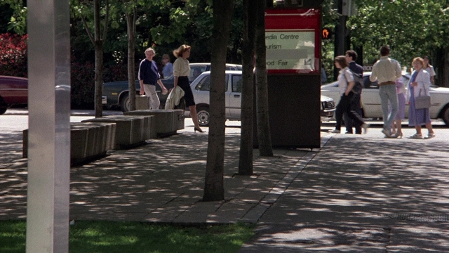Wide shot frame from The Accused — walking, street, car