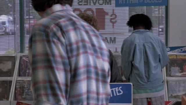 Wide shot frame from The Accused — standing, shirt, poster
